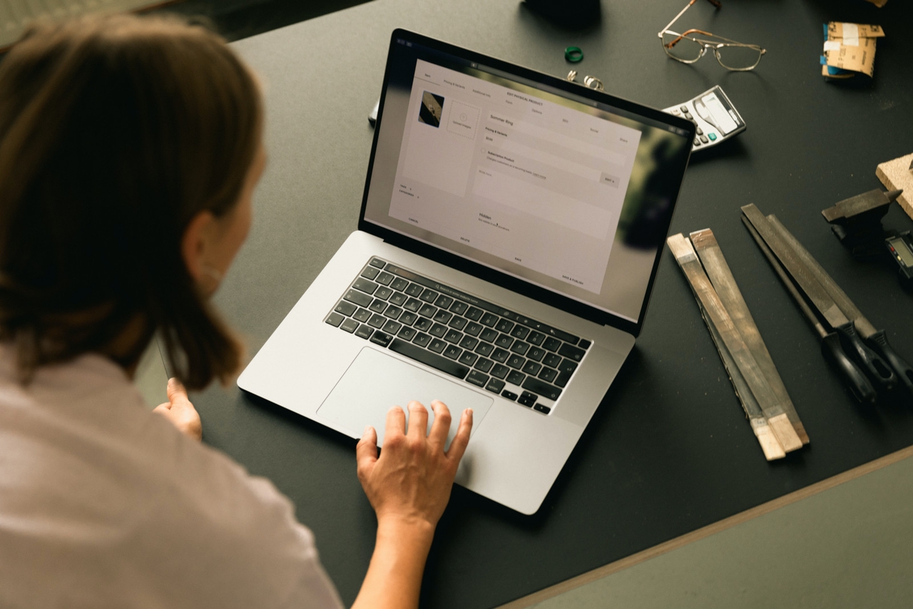 A woman enters alt text for images into her blogging platform on her laptop.