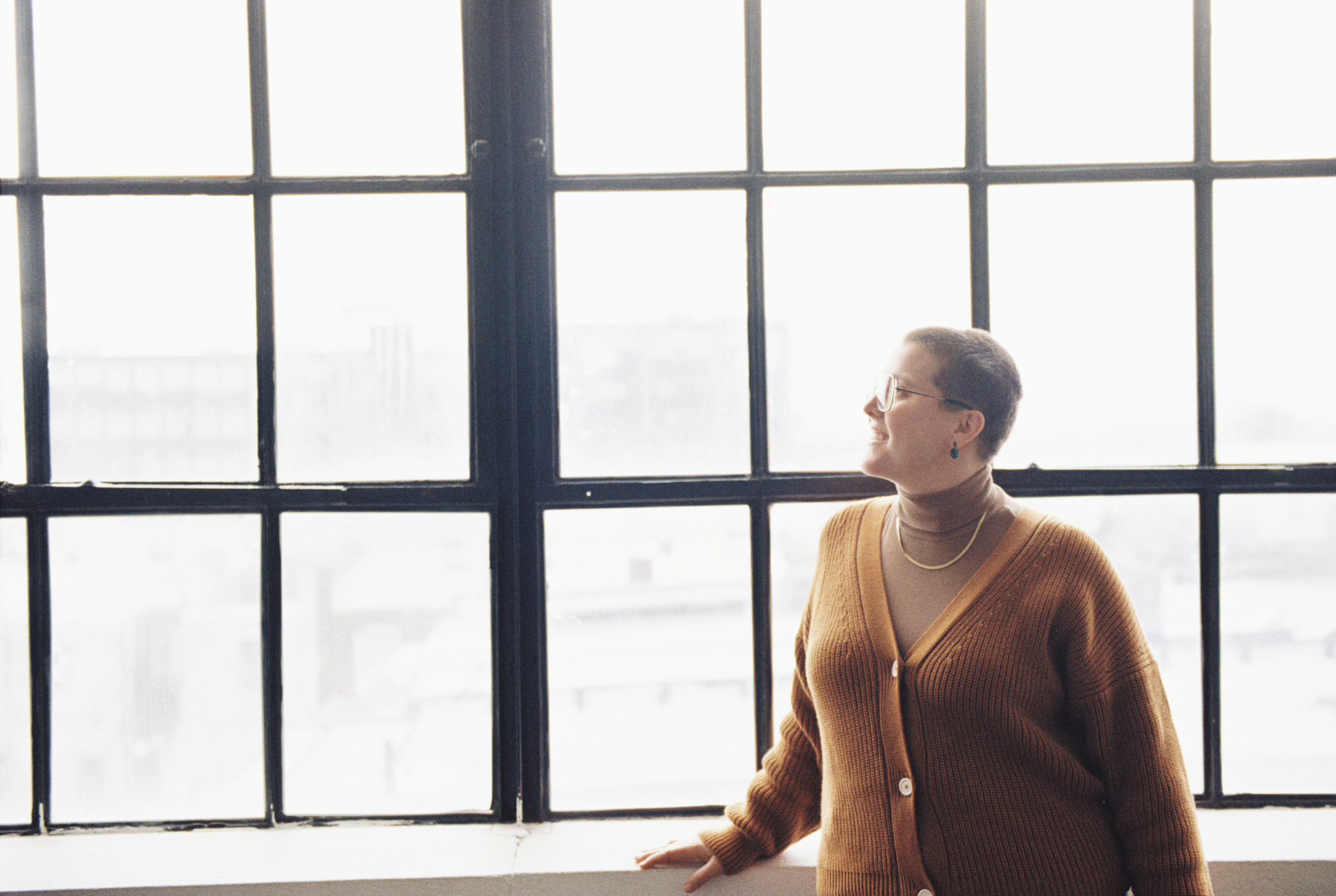 An SEO copywriter looks out a window while discussing how to use Ubersuggest.