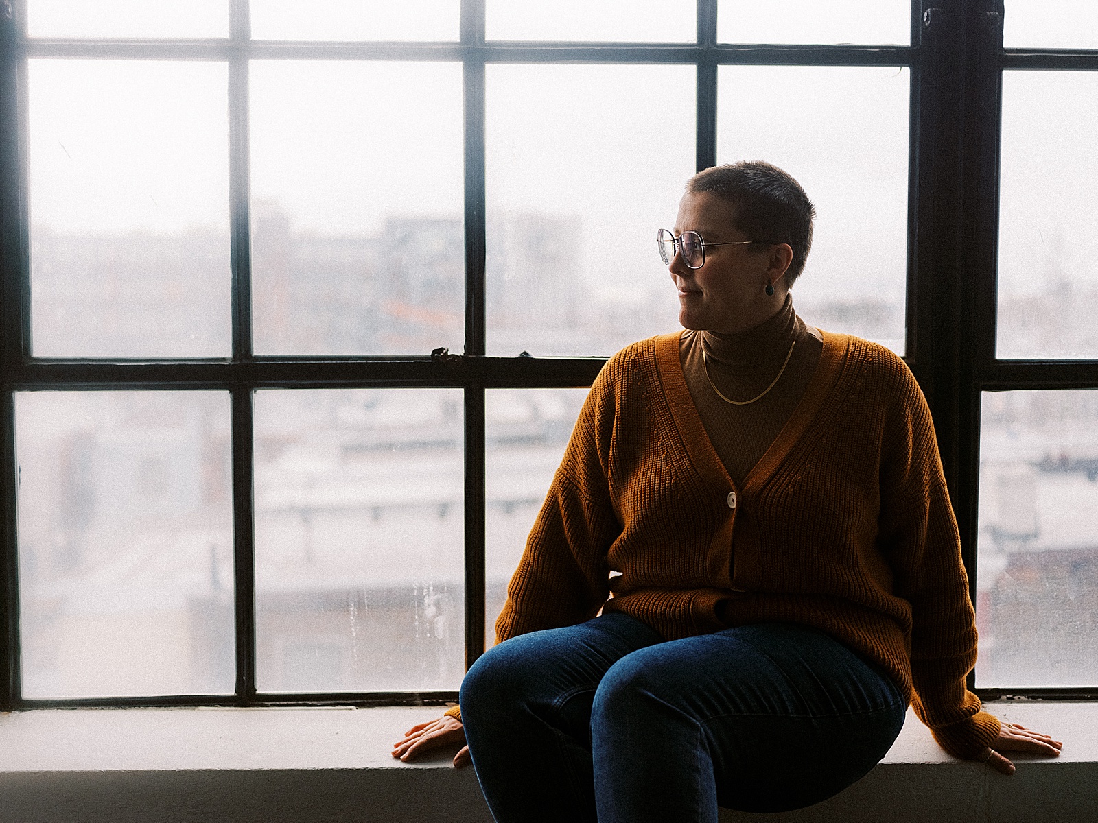 A website copywriter sits on a windowsill talking about a Tonic website.