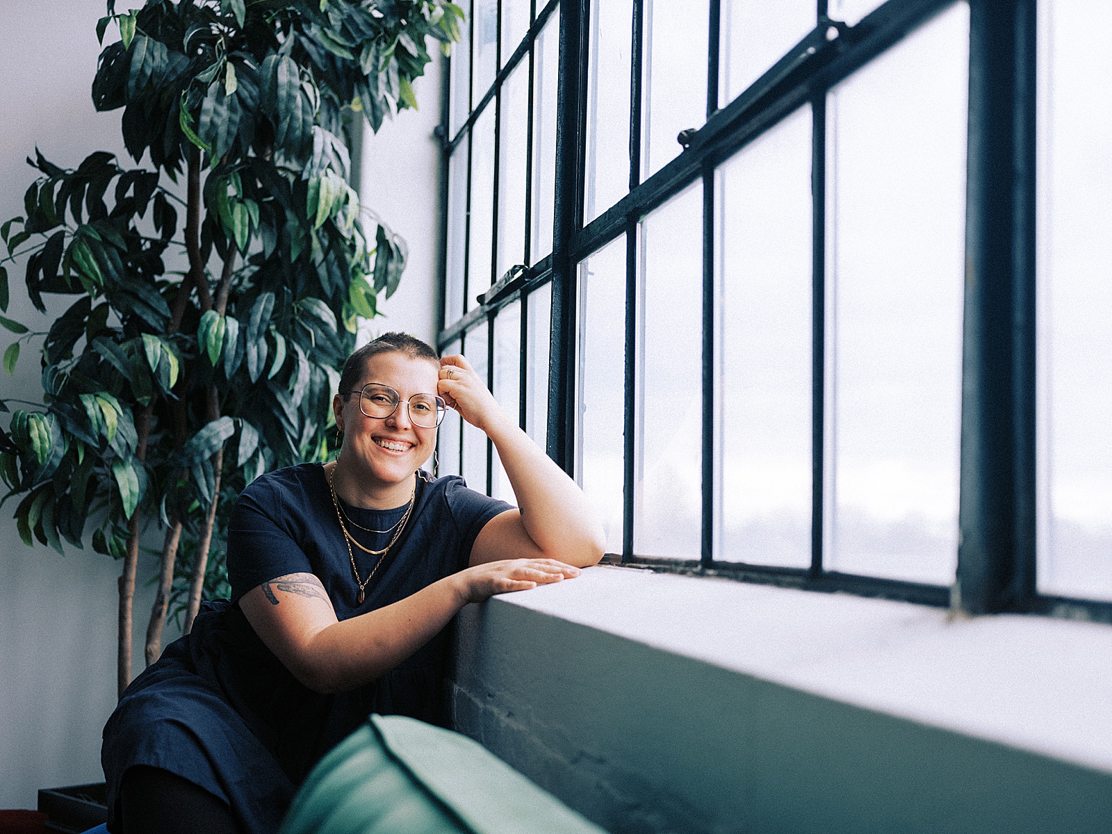 A small business copywriter sits beside a window discussing quotes for entrepreneurs.